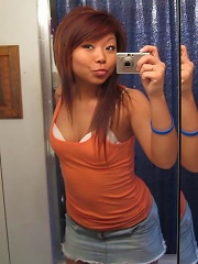 Hot asian teen posing in front of the mirror
